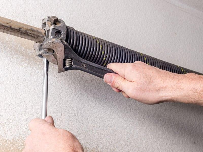 a garage door spring getting maintained to prevent garage door problems