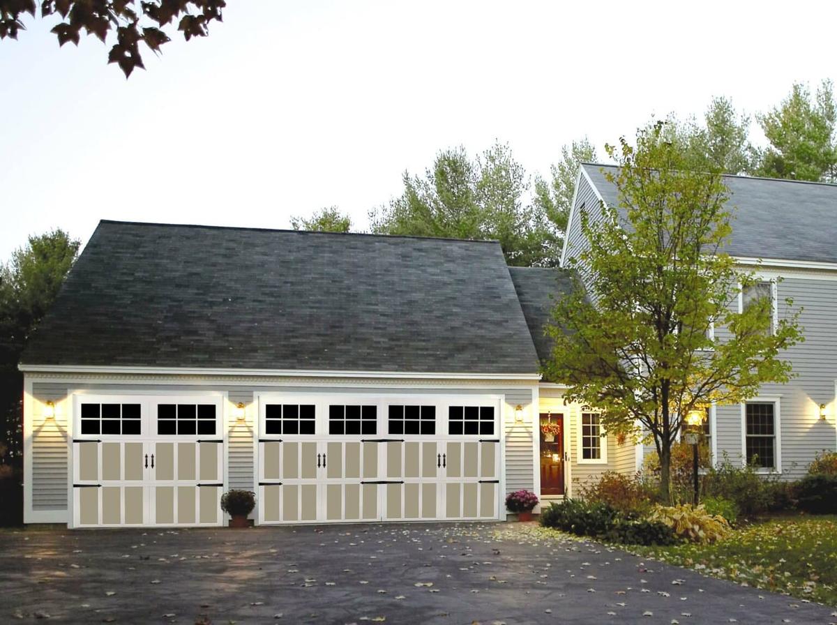 A light home with a dark roof, a well thought garage door blending both shades. From Overhead Door Company.